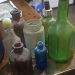Assorted Collectible Glass Bottles Lot, Green Brown Clear Blue Display. Fixed Price $28.00.